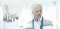 Businessman using digital device to control robot