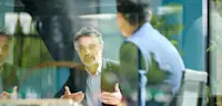 Mature businessman sitting on office balcony having meeting with colleague discussing project and gesturing, planning, togetherness, discussion