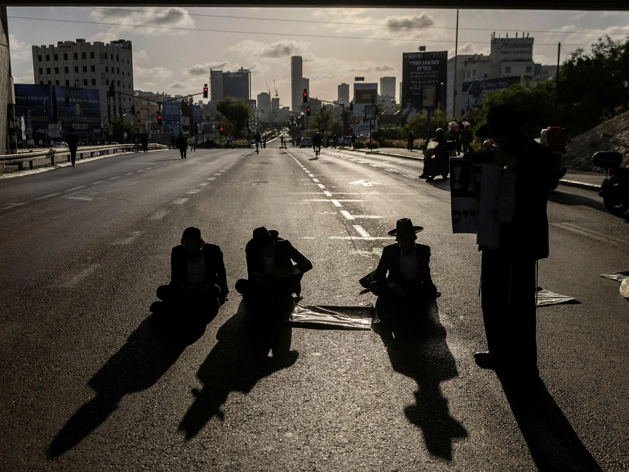 Ultra-Orthodox men blocking a road in central Israel, earlier this year, in protest of the military's arrests of Haredi draft dodgers. Credit: Itay Ron Ultra-Orthodox men blocking a road in central Israel, earlier this year, in protest of the military's arrests of Haredi draft dodgers.