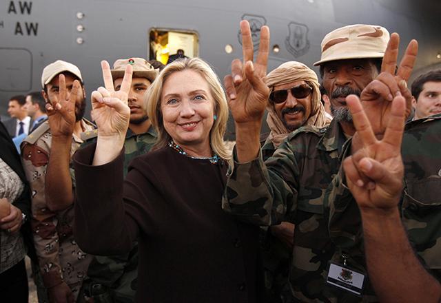 Photo : Minn Post, “Secretary of State Hillary Clinton with Libyan soldiers upon her departure from Tripoli in Libya on October 18, 2011